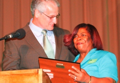 Woman on stage receiving award